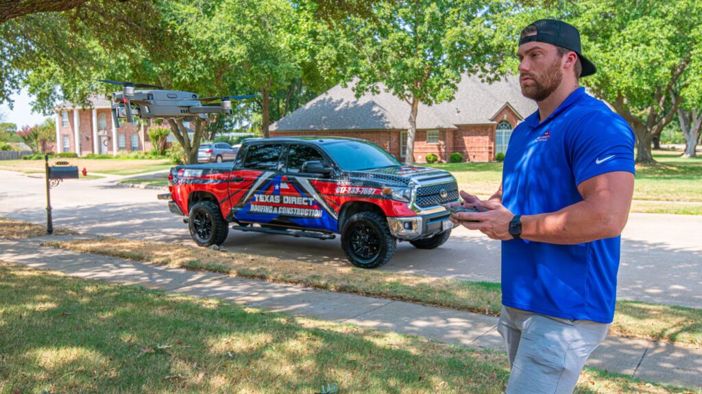 A roofer launching a drone in a front yard to complete a drone roof inspection.