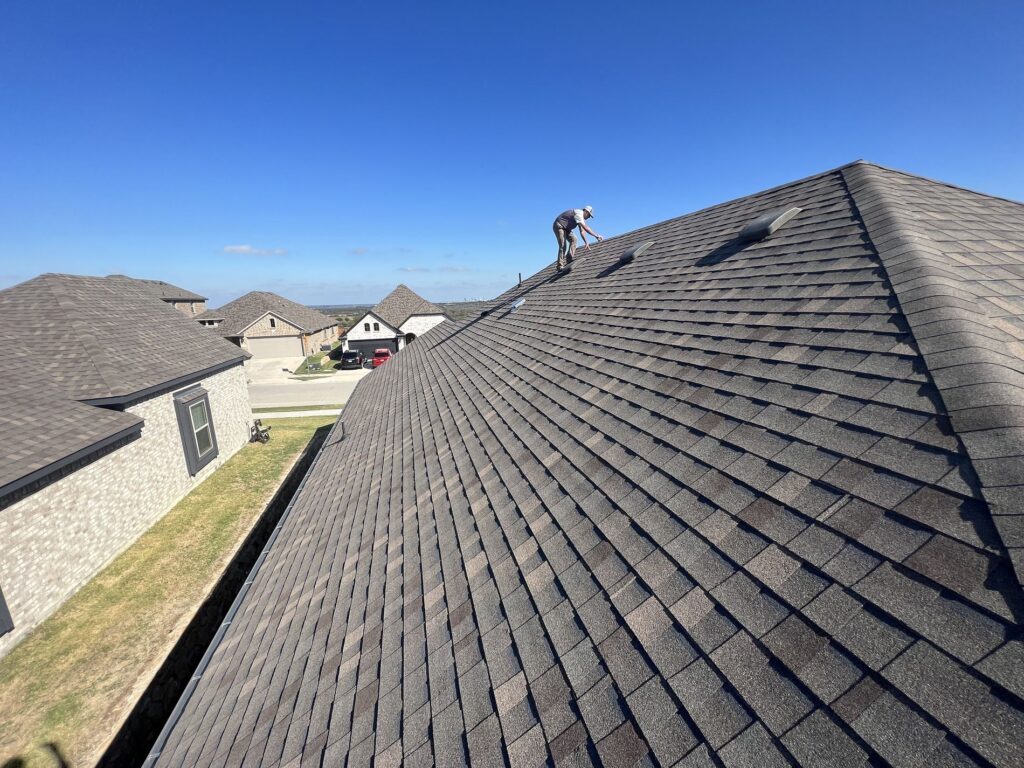 A roof slope full of roof shingles receiving a roof inspection