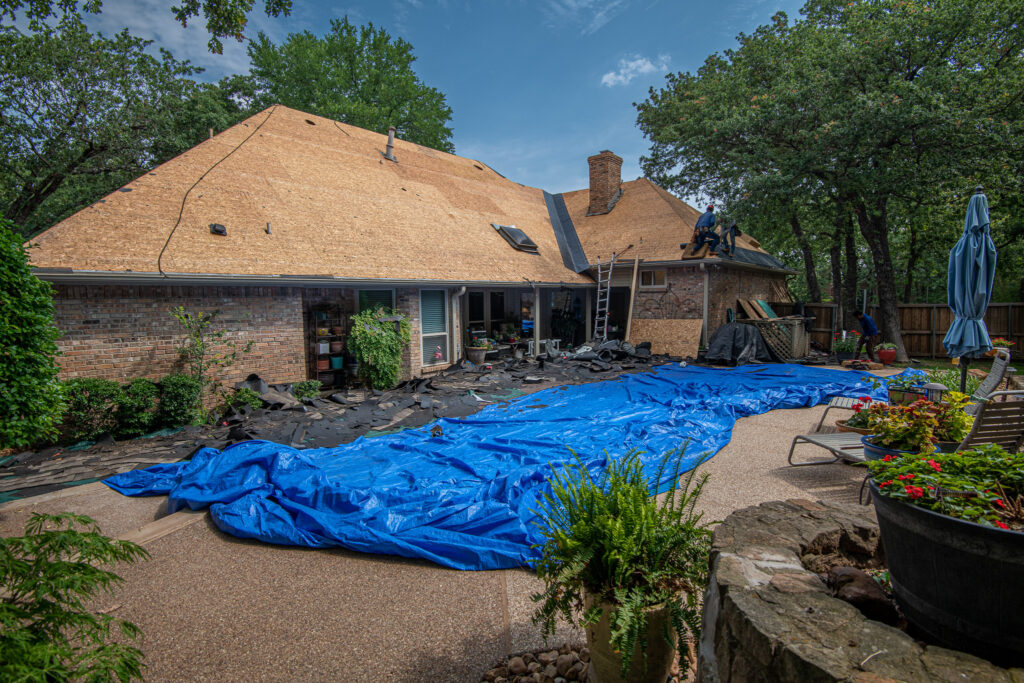 Roof decking being inspected during a residential roof replacement by Texas Direct Roofing